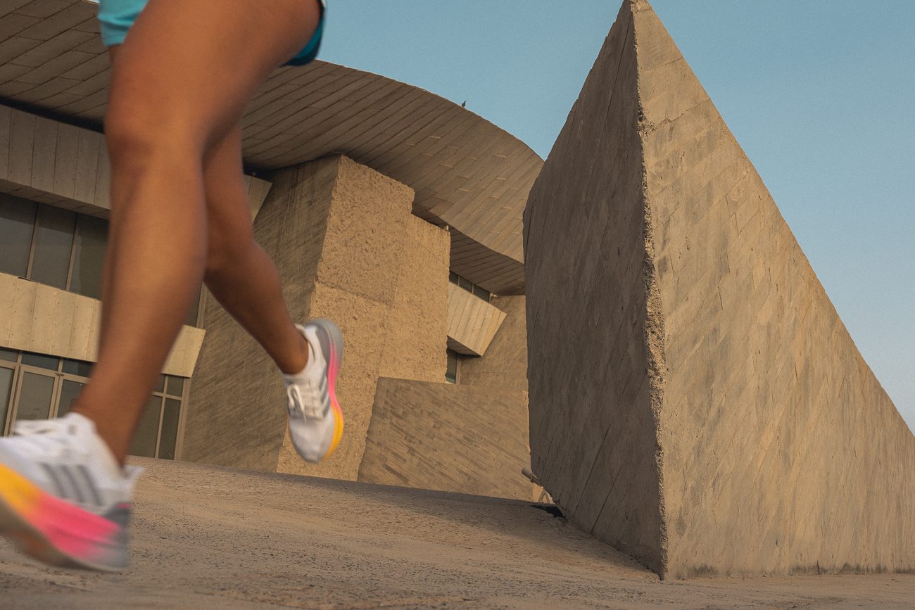 Runner running through frame with a brutalist background